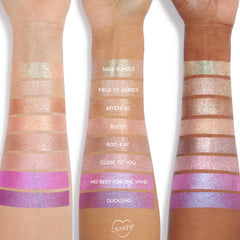 Super Cool Jelly Much Shadow eyeshadow by Colourpop swatched on three arms, showing shimmery pastel and vibrant shades from sage and champagne tones to bright pinks and purples, highlighting pigment and finish across multiple skin tones.
