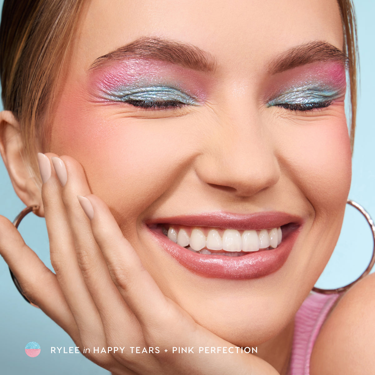 Smiling model wearing Jelly Much Gel Eyeshadow Sticks in Happy Tears and Pink Perfection