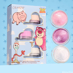 ColourPop Jelly Much Shadow Play All Day trio showcasing three shimmery gel eyeshadows - pearl pink, vibrant magenta, and icy white - lined in open pots beside a Disney Pixar Toy Story sky-blue box with Hamm, Lotso, and Forky; set includes 3 x 6.5g jars.