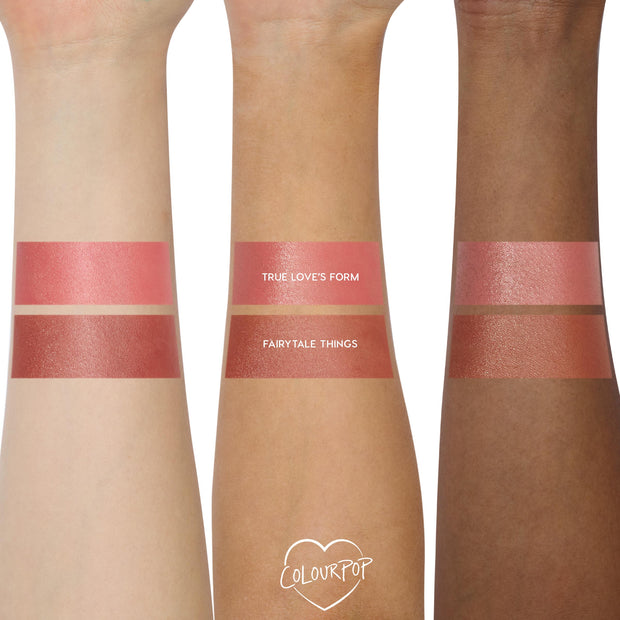 ColourPop Lip and Cheek Balm swatches, Fairytale Things shade, sweep across three arms (light, medium, deep) beneath a comparison stripe labeled True Love’s Form, showing a rosy mauve, dewy finish for lips and cheeks.