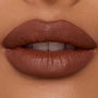 Lips wearing ColourPop Ultra Blotted Lip in Espresso Martini, a warm espresso-brown shade, shown close-up to showcase its soft-matte blotted finish and smooth, even coverage under studio lighting.
