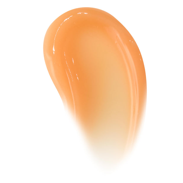 Curved swipe of Orange Vanilla ColourPop Lip Mask, a glossy sheer peach-orange swatch highlighting its smooth, hydrating balm texture and high-shine finish on a clean white background.