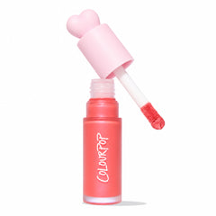 ColourPop Liquid Blush I Love It opened, doe-foot applicator lifting coral pink blush from a frosted bottle with a pastel pink heart cap, ColourPop logo visible, and an Allure Best of Beauty 2025 award badge on a white background.
