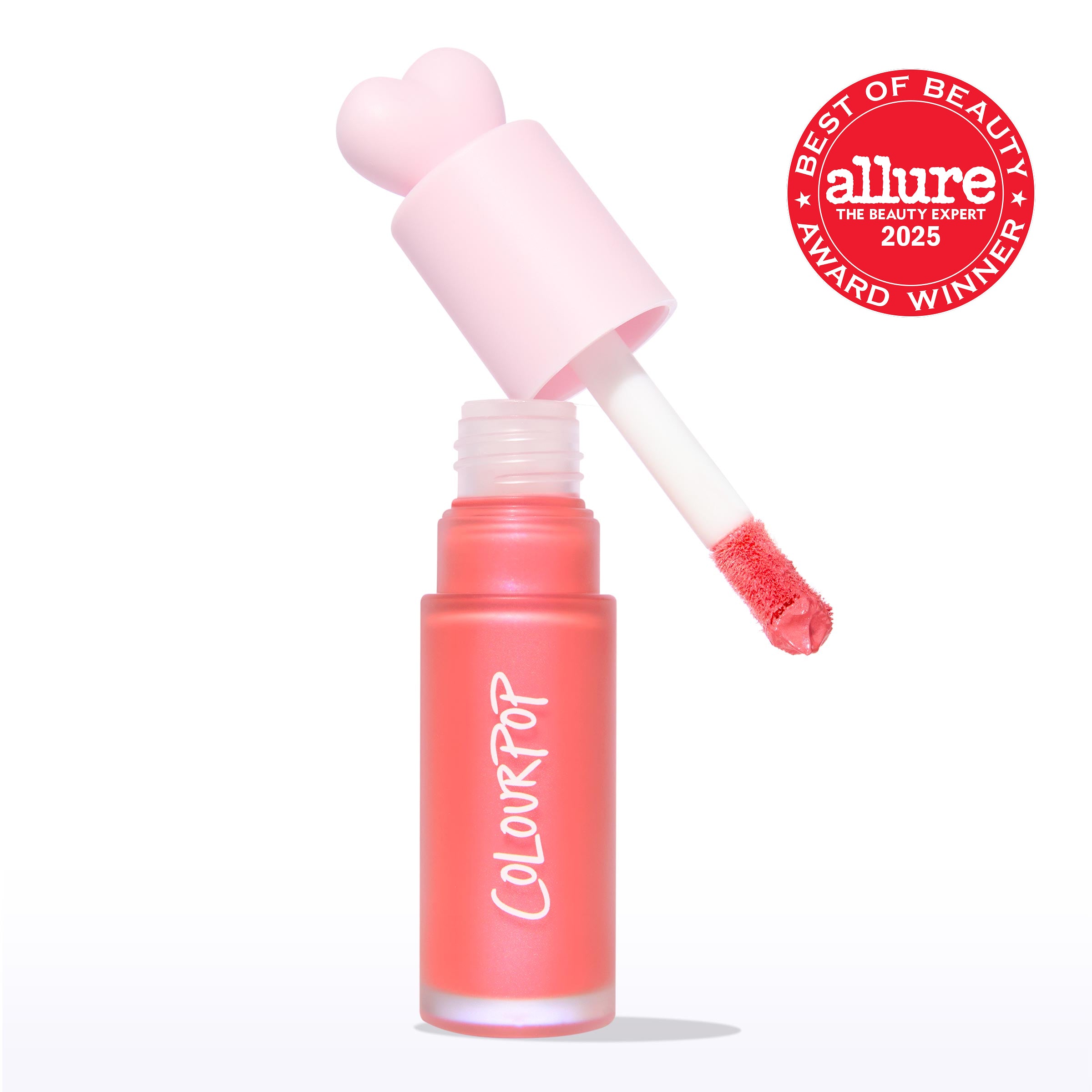 ColourPop Liquid Blush I Love It opened, doe-foot applicator lifting coral pink blush from a frosted bottle with a pastel pink heart cap, ColourPop logo visible, and an Allure Best of Beauty 2025 award badge on a white background.