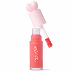Super Shy ColourPop Liquid Blush with a heart-shaped pink cap, doe-foot applicator lifted showing a bead of peachy-pink pigment, in a frosted tube with vertical COLOURPOP logo and an Allure 2025 Best of Beauty badge on white.