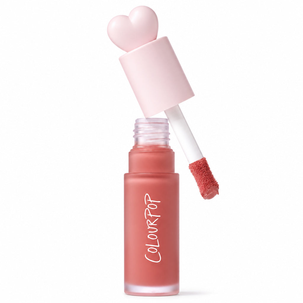 ColourPop Liquid Blush in THX shown open as the doe-foot applicator lifts a rosy peach tint from a frosted bottle with a pink heart cap, COLOURPOP logo visible, on white background with Allure Best of Beauty 2025 award badge.