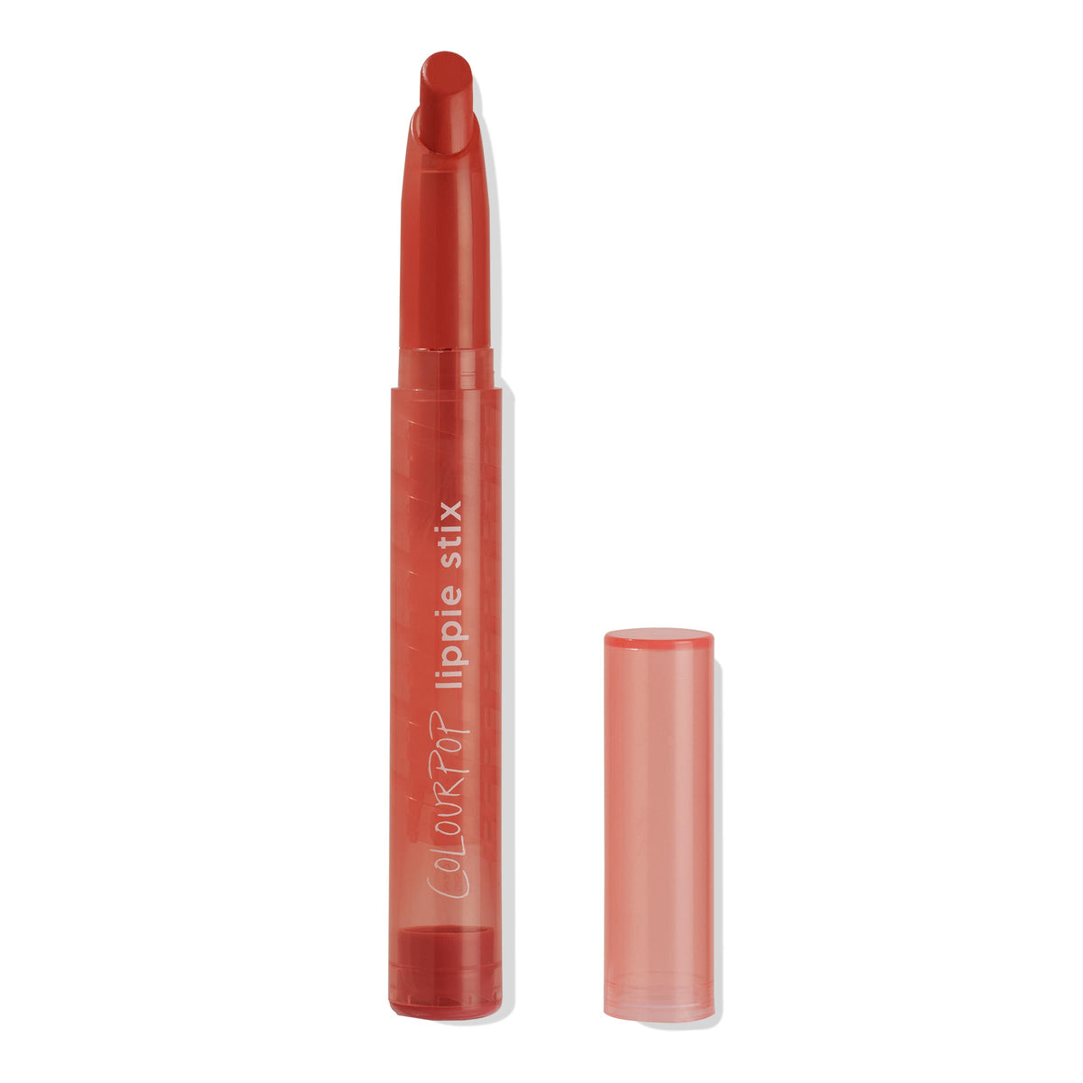 ColourPop Lippie Stix Love Life shown uncapped, angled red lipstick crayon extended, with matching translucent coral tube and the cap set beside it on a white background.
