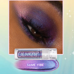 ColourPop Chrome Liquid Shadow 'Same Vibe' delivers a vivid purple-to-blue multichrome finish - shown on a closed eyelid with sparkly, blended pigment; the clear tube and swatch sit below against a pastel gradient background.