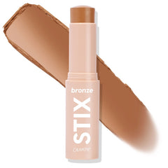 ColourPop Bronzer Stix in Moonstone Beach standing uncapped, the twist-up cream bronzer bullet leaving a warm tan swipe behind it, shown close-up on a white background for shade reference; ideal for sun-kissed contour.
