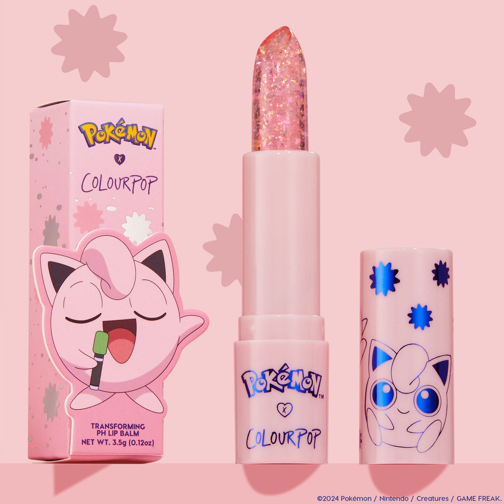 ColourPop pH Lip Balm Sing stands uncapped, revealing a clear glittery bullet beside its pink Pokémon x ColourPop box and matching cap with blue starbursts and Jigglypuff art, set against a pastel pink background.