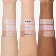Three forearms display Sweet Sips Super Shock Shadow full collection set swatches—shades Extra Ice, Sweet Sip, and Raspberry Fizz—showing shimmery champagne and pink tones on light, medium, and deep skin for US makeup lovers.