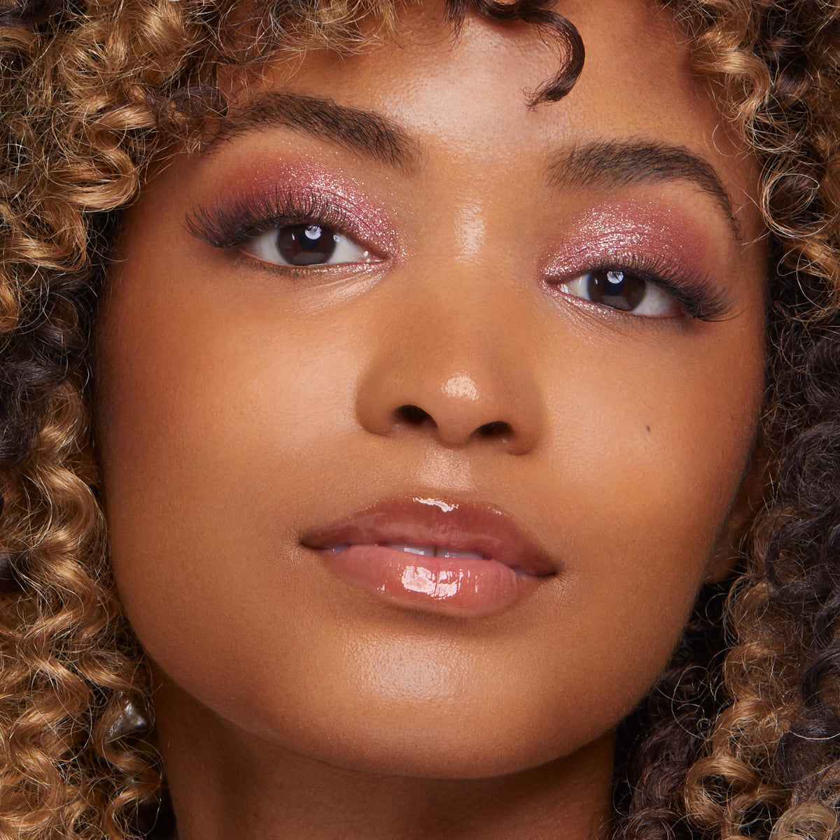 ColourPop Pretty Fresh Creamy Concealer in Medium Dark 145 W smoothing and brightening under the eyes on a model, showcasing an even, natural radiant finish with soft shimmer eyeshadow and glossy nude lips in a studio close-up.