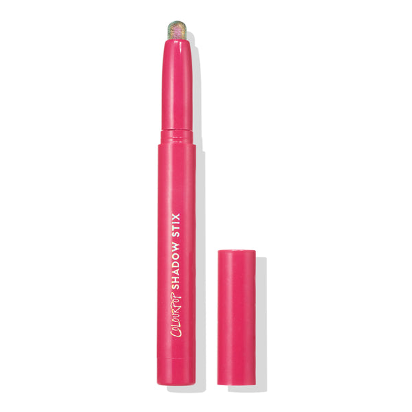 Colourpop Galaxy Shadow Stix in bright pink tube with cap off, revealing a shimmering multi-color eyeshadow stick, standing upright on a white background for easy-to-use cream eye makeup.