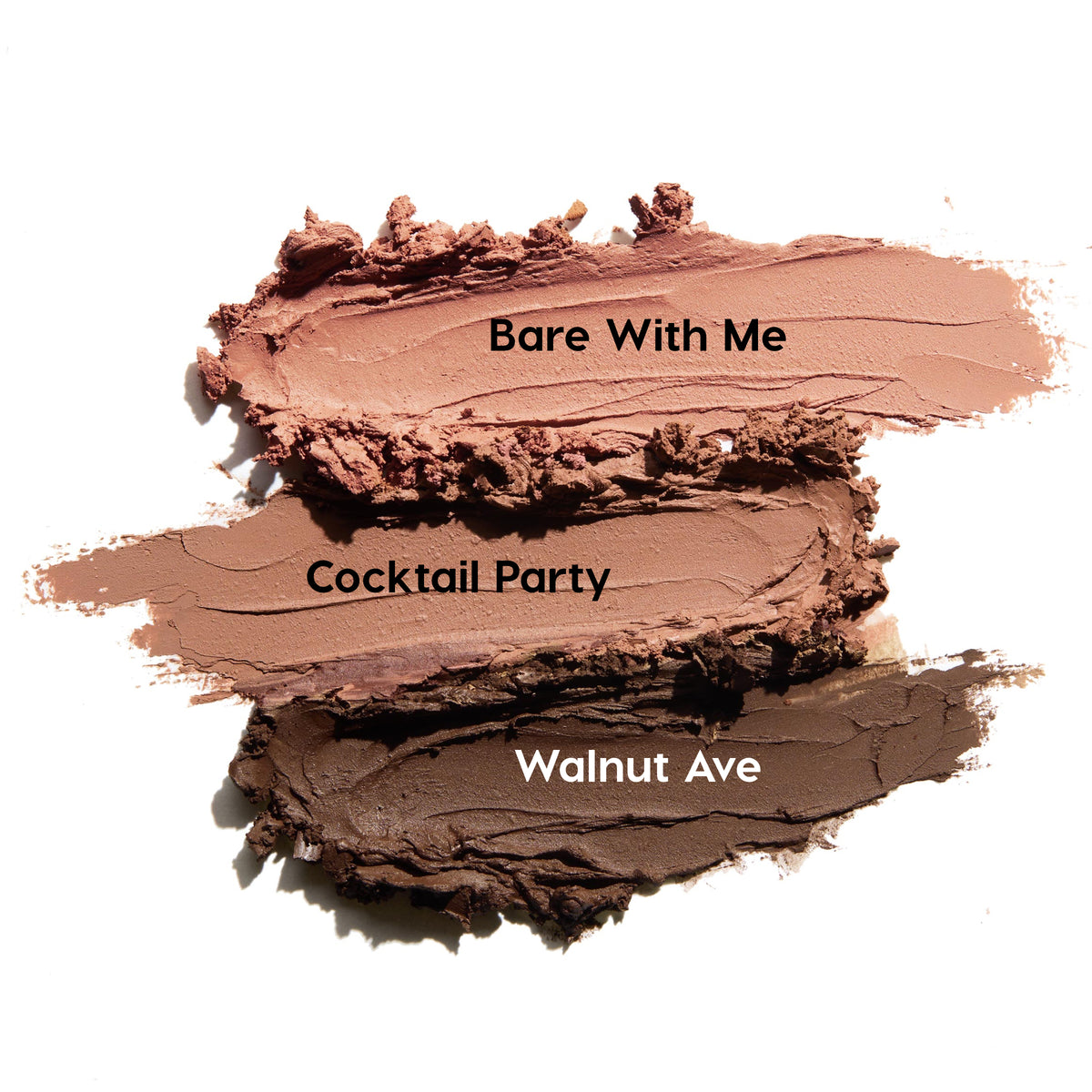 Three matte nude ColourPop Shadow Stix swatches - Bare With Me (soft rosy nude), Cocktail Party (warm beige), and Walnut Ave (deep chocolate brown) - smeared side by side on a white background, showing the Matte Nudes eyeshadow stick pigment and texture.