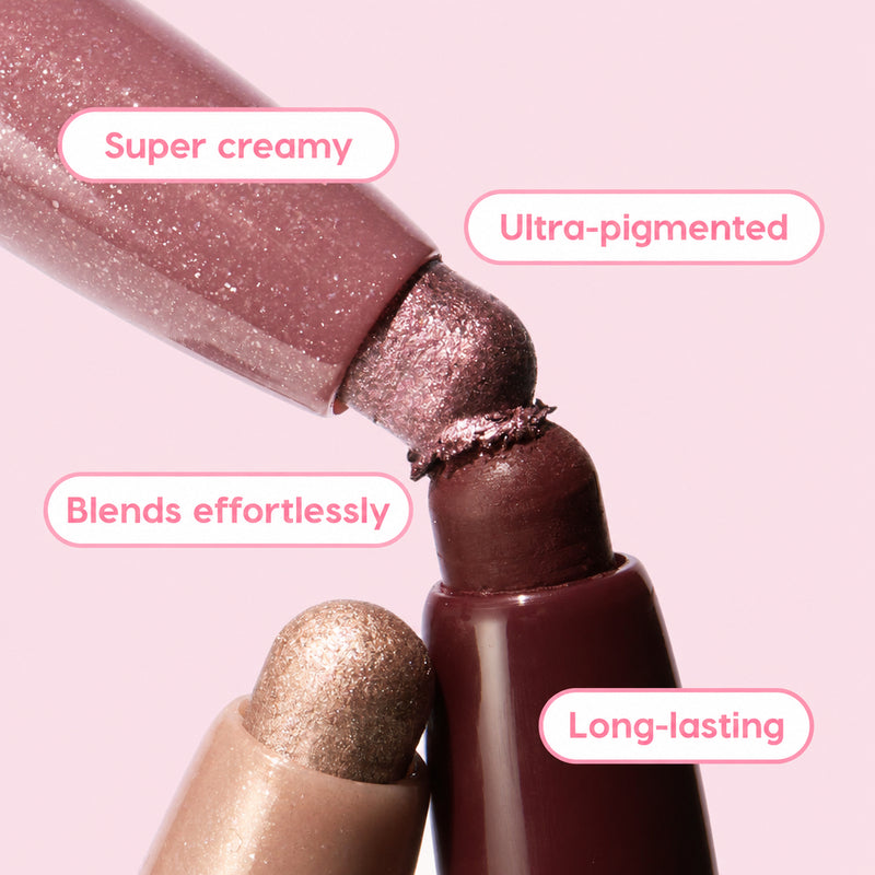 Rose Goals ColourPop Shadow Stix twist-up eyeshadow tips touch in a close-up, showcasing creamy, ultra-pigmented rose and mauve shimmer that blends effortlessly and lasts long, with a champagne shade below and deep berry casing in studio light.