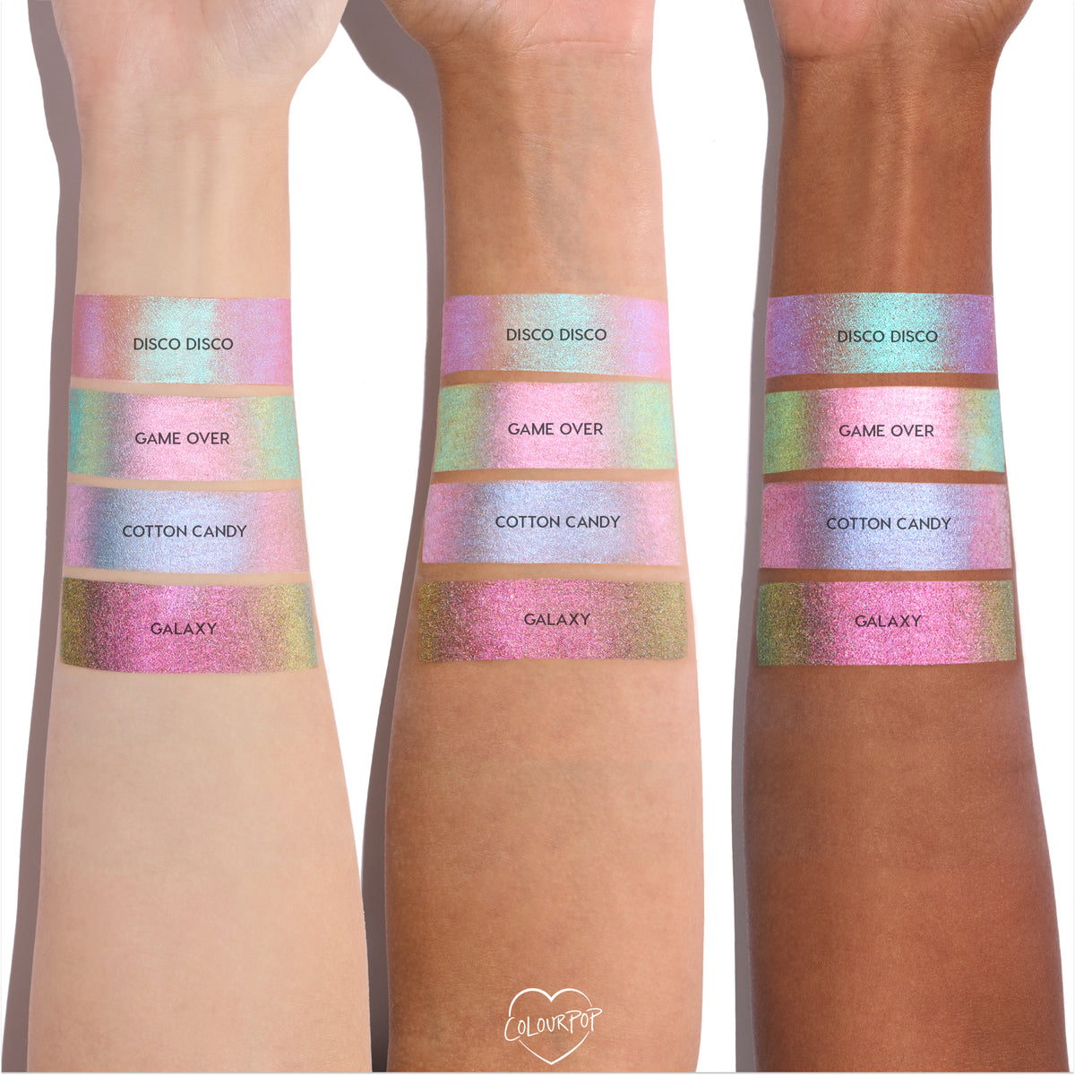 Colourpop Disco Disco Shadow Stix swatched on three skin tones, showing the shimmery pink duochrome finish alongside Game Over, Cotton Candy, and Galaxy shades in wide metallic bands on forearms.