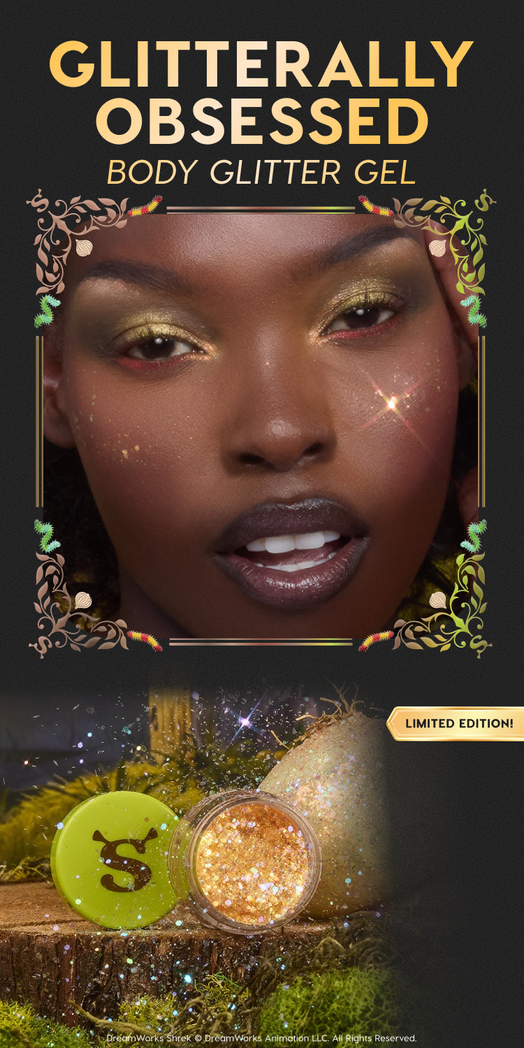 Glitterally Obsessed body glitter gel sparkles on a model’s eyes and cheeks while an open jar of gold chunky glitter with a neon green Shrek “S” lid rests on moss, highlighting the limited‑edition ColourPop collaboration.
