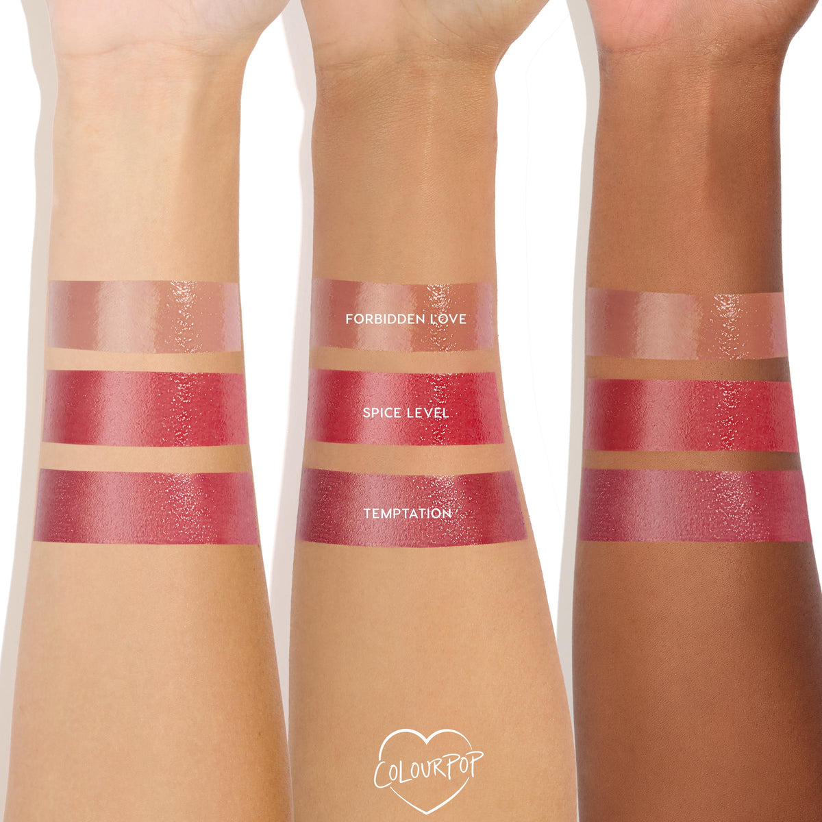 Temptation swatched on three forearms of different skin tones, the lowest glossy deep rose‑plum stripe, with nude Forbidden Love and bright Spice Level above, showcasing the high‑shine ColourPop So Juicy Plumping Gloss.