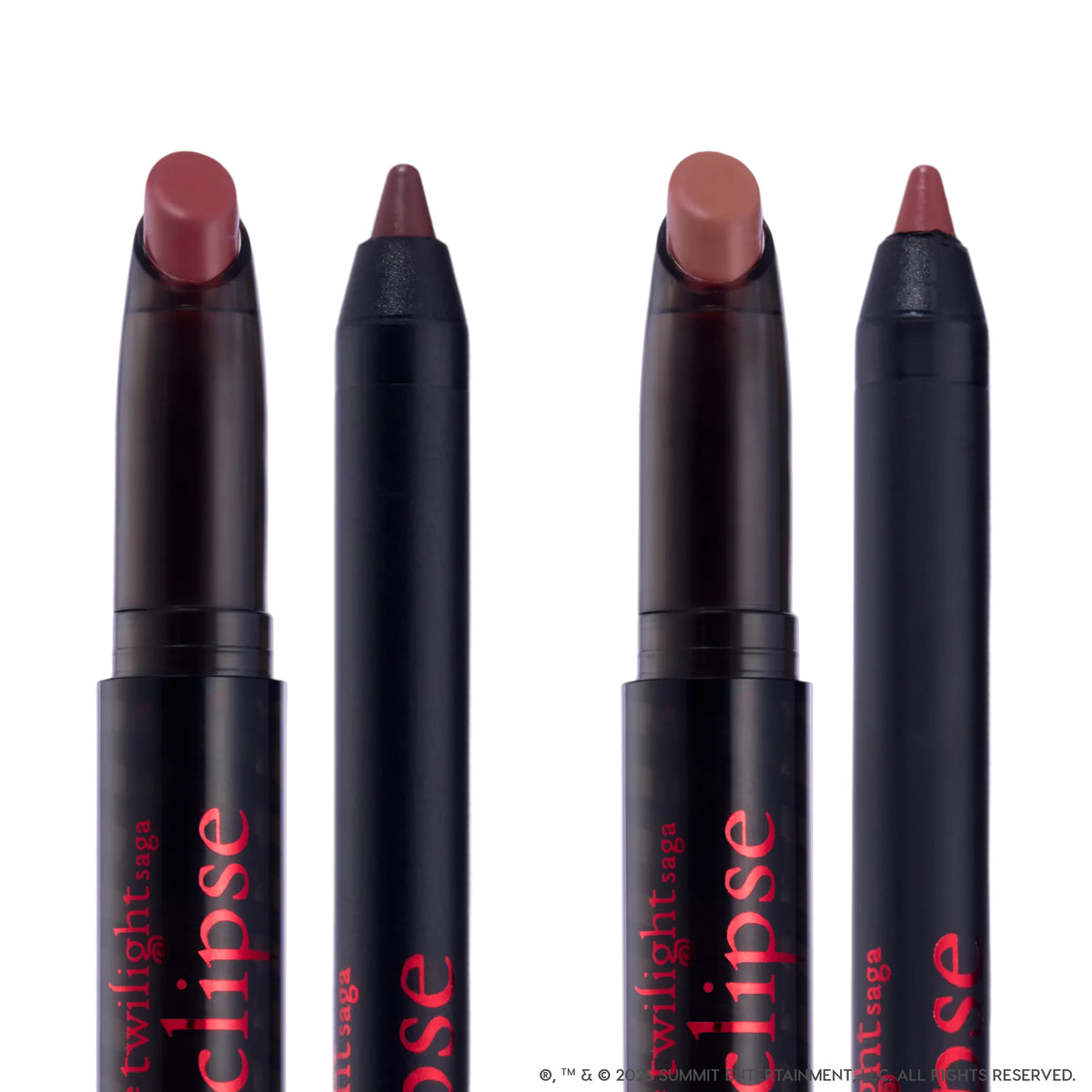 Immortal Kiss Lippie Stix Duo from the Twilight collection standing upright against a white background, showing two creamy mauve-brown lipstick crayons and two matching liners in sleek black tubes with red Eclipse branding.