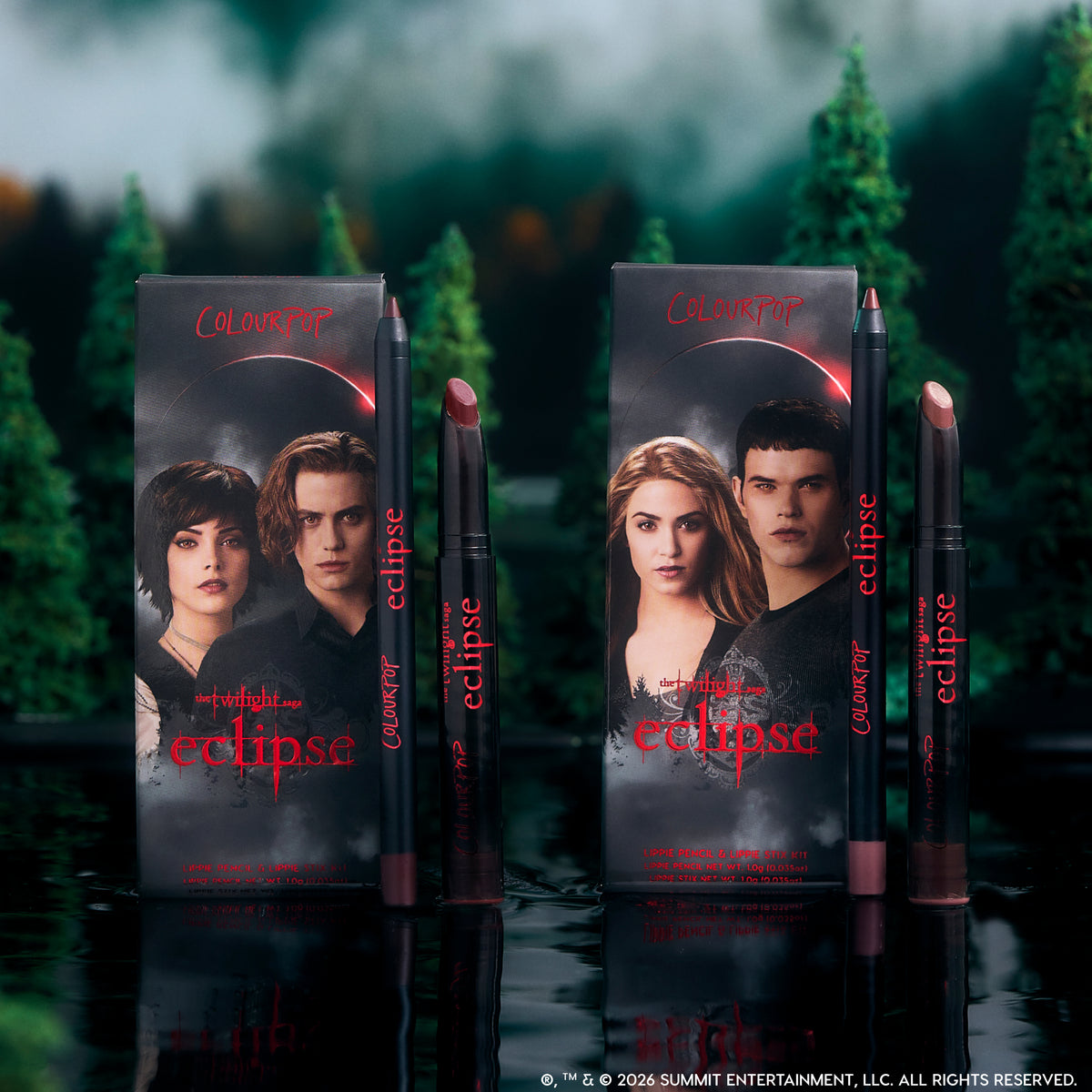 ColourPop Twilight Immortal Kiss Lippie Stix Duo stands upright on a reflective lake surface, with Eclipse-themed character boxes and matching deep nude and berry lip pencils and sticks framed by a dark, misty forest backdrop.