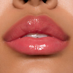 Glossy pink lips showcasing ColourPop Ultra Glossy Lip, shade Experiment 626, catching bright studio light with a glassy finish in a tight close-up beauty swatch.