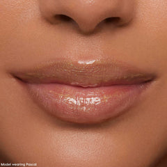 Lips wearing ColourPop Ultra Glossy Lip Pascal, catching studio light in a sheer, high-shine finish with fine iridescent shimmer; extreme close-up beauty shot emphasizing smooth, hydrated lips and glossy payoff.