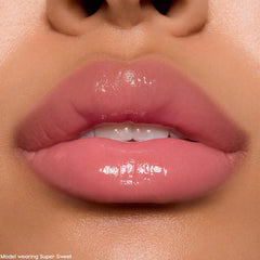 Soft pink lips wearing Keepin’ It Sweet Ultra Glossy Lip, a ColourPop Ultra Glossy Lip, reflecting a glassy high-shine finish in a tight studio close-up that showcases smooth, hydrated texture and a sheer rosy tint.