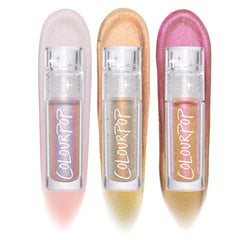 Three ColourPop Chrome Liquid Shadow tubes - Vibe Shift trio - standing over bold multichrome swatches: lilac-to-peach, silver-gold-to-green, and rose-to-bronze, with clear star-detailed caps and ColourPop logos on a white studio background.