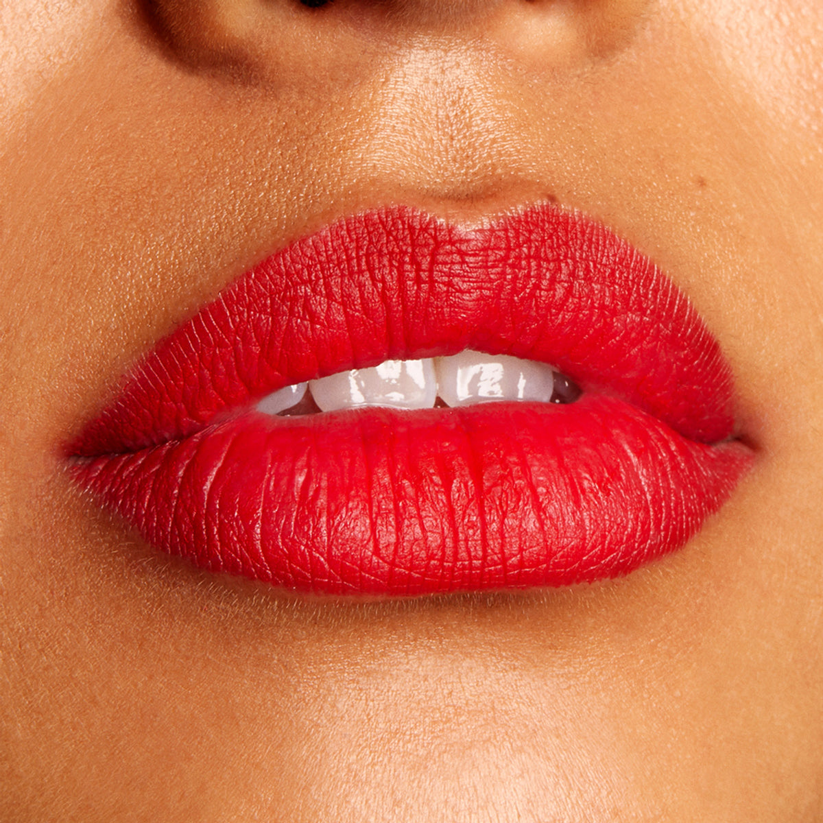 Bold red lips lined and filled with Bossy ColourPop Lippie Pencil, showing a crisp outline and smooth, full-coverage, creamy finish in a tight close-up beauty shot.