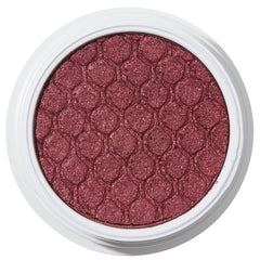 ColourPop Drift Super Shock Shadow displays a metallic cranberry-burgundy shimmer, pressed with a quilted scale pattern, sitting in a round white pot on a plain white studio background.