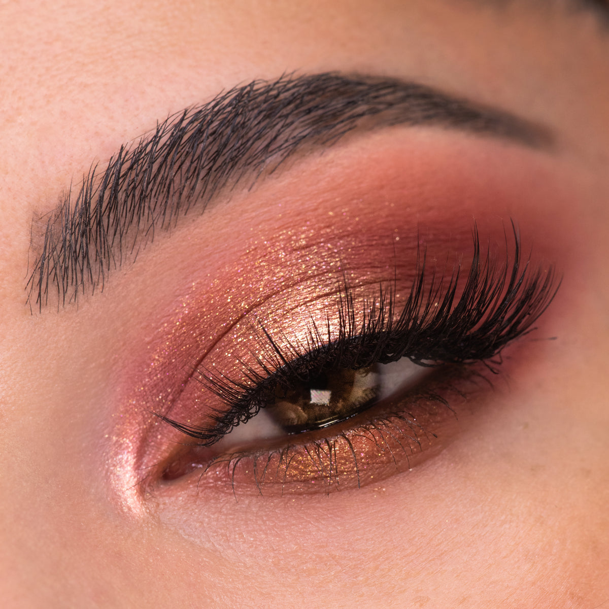 Shimmering rose-gold, copper, and berry eye look blends across the eyelid with a bright inner-corner highlight, showcasing By The Rosé Shadow Palette, a ColourPop Shadow Palette, on smooth skin with full lashes in a close-up.