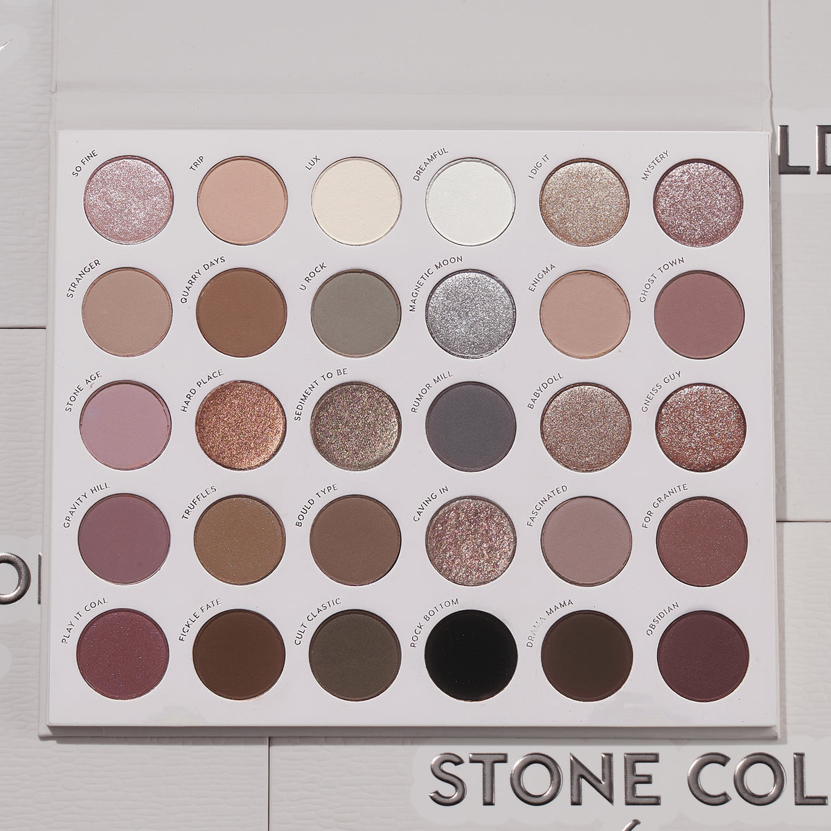 Bold + Bare ColourPop Shadow Palette Set presents an open 30-pan cool‑toned eyeshadow palette with matte and shimmer taupes, mauves, grays, silvers, plum and black, arranged in neat rows on a white tray, lid open on a light textured surface.