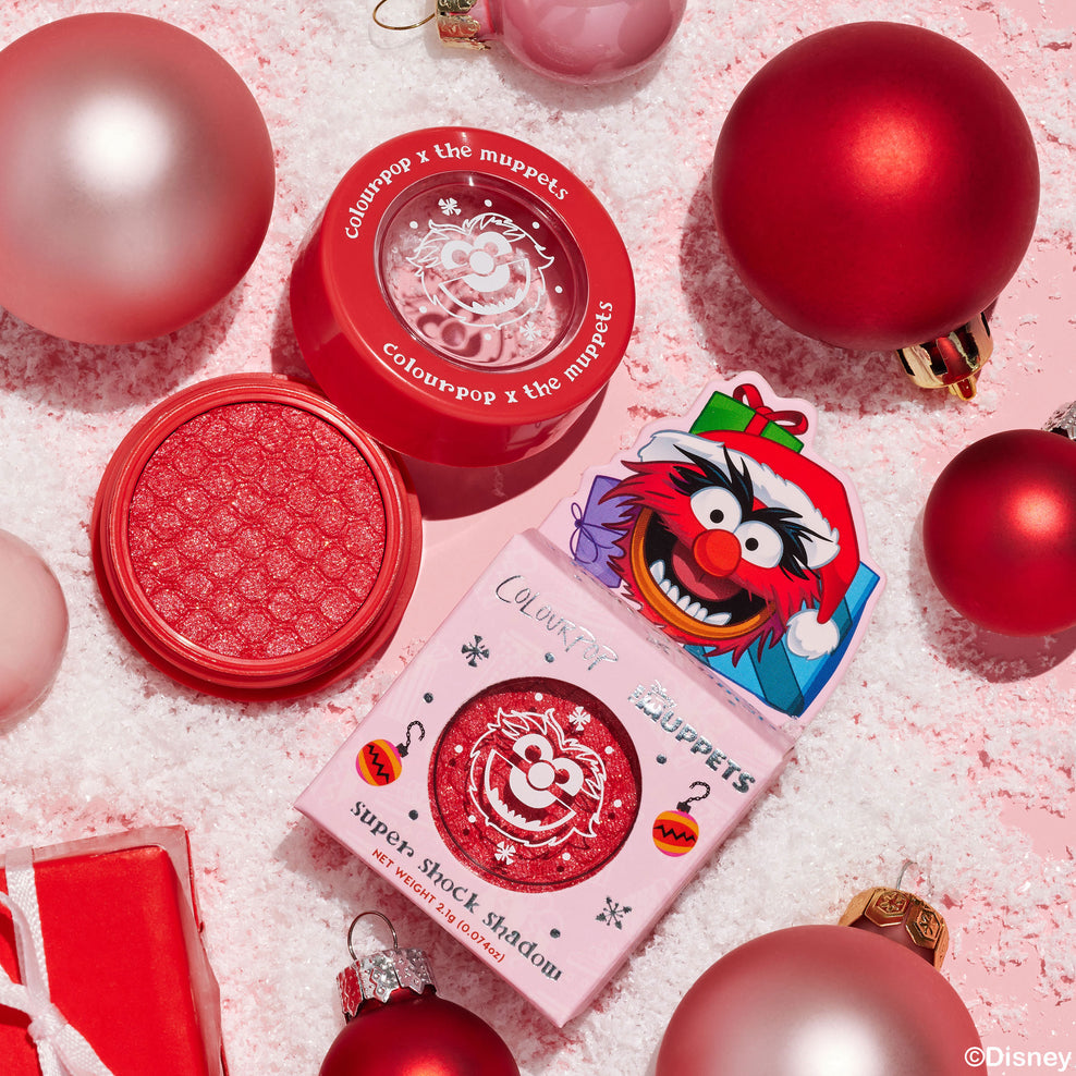 Muppets Beat Drums Super Shock Shadow on festive pink background with christmas ornaments