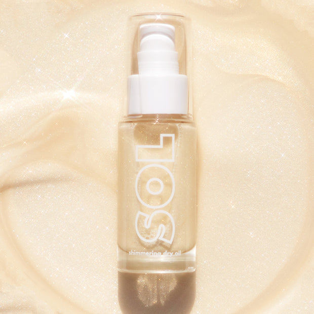 SOL Body Platinum Shimmering Dry Oil a shimmering ivory gold with highlights of silver and gold pearl on model