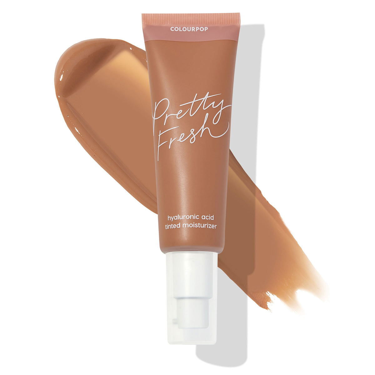 ColourPop Pretty Fresh Tinted Moisturizer in Medium Dark 16 N stands upright with a white pump and pink cap, labeled “hyaluronic acid,” set over a wide caramel-brown swatch that displays the neutral medium-dark shade on a white background.