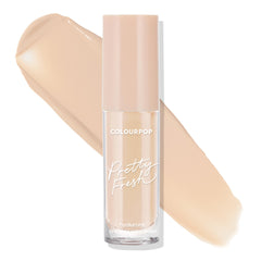 ColourPop Pretty Fresh Creamy Concealer in Light 45 W stands upright in a clear tube with a blush cap, showing its hyaluronic formula as a wide peach‑beige swatch sweeps behind on a white background, emphasizing the light warm shade.
