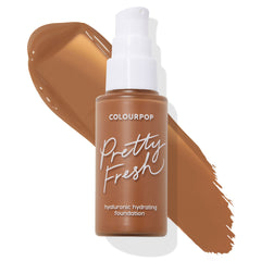 Pump bottle of ColourPop Hyaluronic Hydrating Foundation Pretty Fresh in shade Deep Dark 185 W set over a wide warm-brown swatch, showcasing the deep warm undertone on a clean white background.