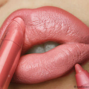 ColourPop Lippie Stix in Caramella, a flirty coral hue on lip