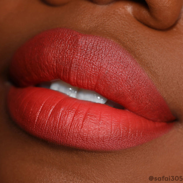 ColourPop Lippie Stix in Who Run This, a vibrant rusty red on model