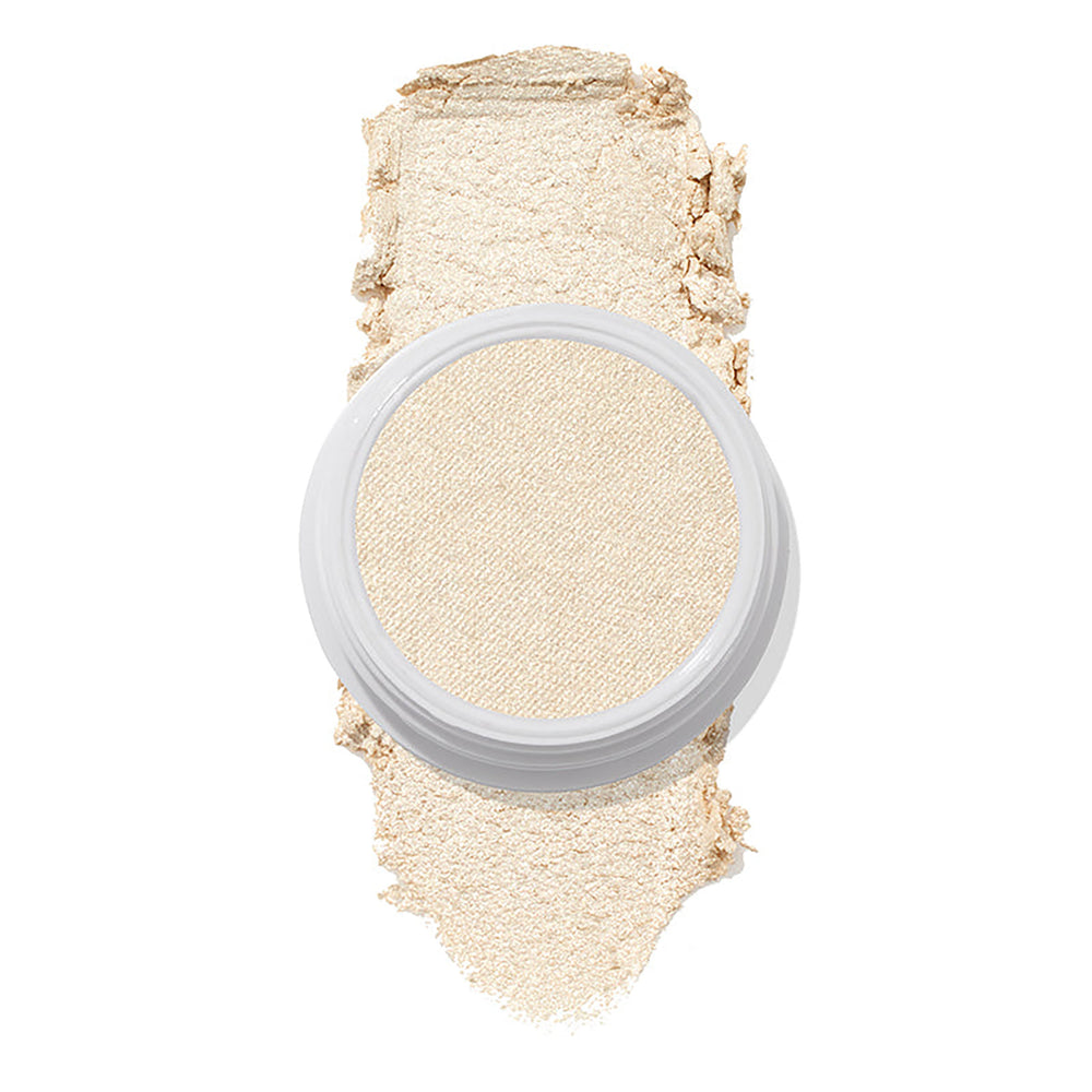 ColourPop Stole the Show Super Shock Highlighter in a round white pot sits atop a thick champagne‑pearl swatch on a white background, showing its luminous shimmer finish for face highlighting.