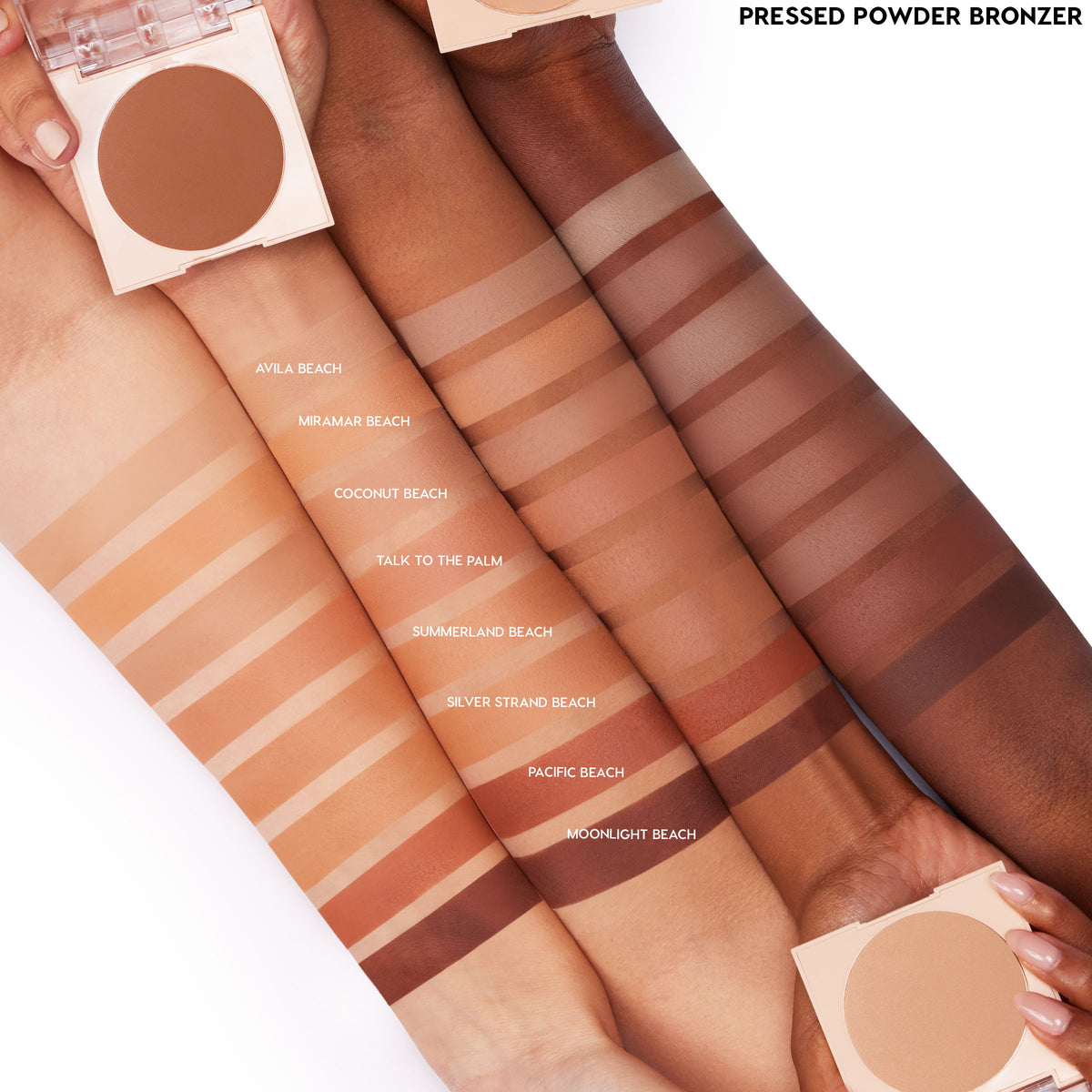 ColourPop Pressed Powder Bronzer in Avila Beach swatched in even stripes across four arms of different skin tones, with open compacts in view; warm tan matte payoff shown alongside other bronzer shades for comparison.