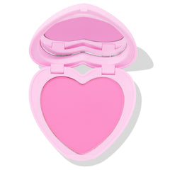 Hot 2 Touch ColourPop Pressed Powder Blush opens to reveal a heart-shaped pan of bright cool-toned pink pressed powder in a pastel pink heart compact with built-in mirror, shown half-open on a white background.