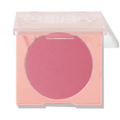 New to U ColourPop Pressed Powder Blush compact displaying a rosy pink pan, lid half-open on a peach square case with a clear top, photographed against a white studio background with a soft shadow.