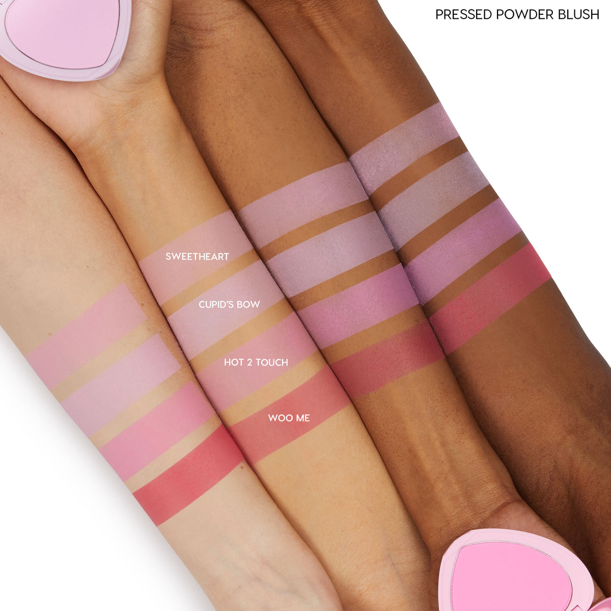 Woo Me pressed powder blush by ColourPop swatched on three arms, showing a rich rosy-pink stripe labeled “WOO ME” under Sweetheart, Cupid’s Bow, and Hot 2 Touch, demonstrating smooth pigment across light, medium, and deep skin tones.
